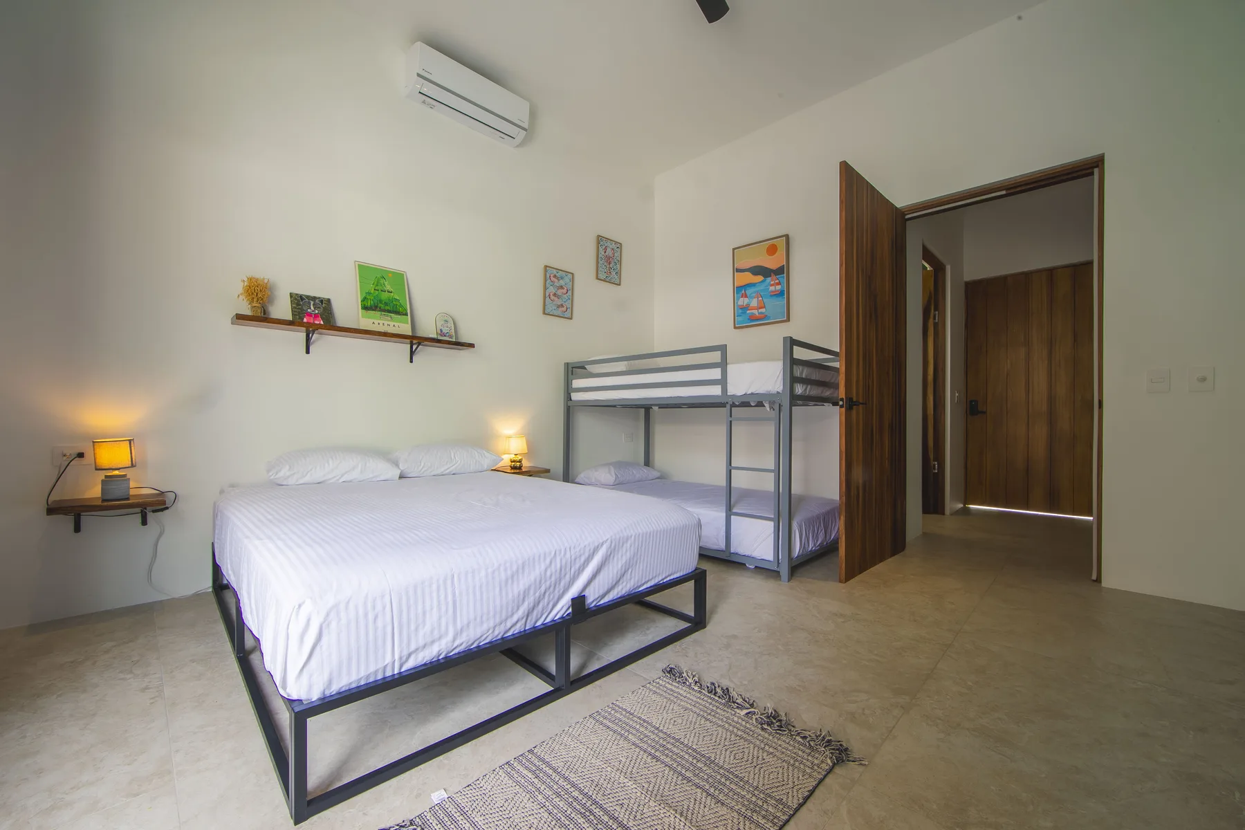 Queen bedroom with bunk beds and garden view at Villa Amara