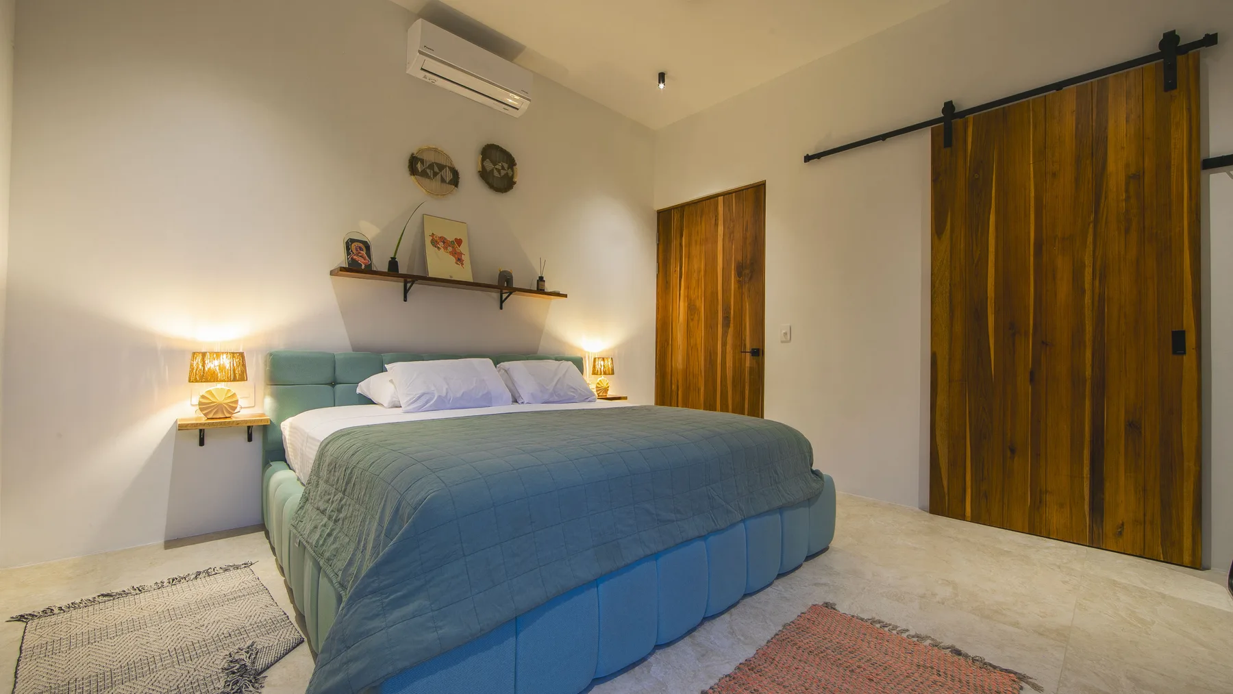 King bedroom with warm wood details at Villa Amara